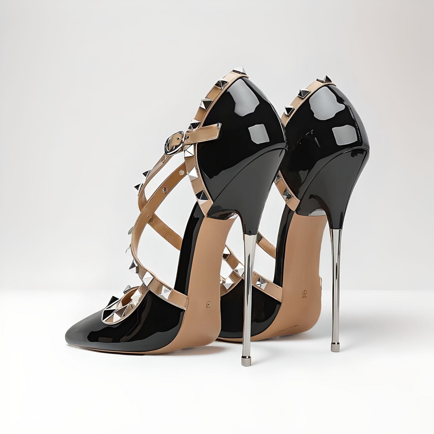 Back view of black patent stiletto pumps showing heel, studs, and ankle strap closure
